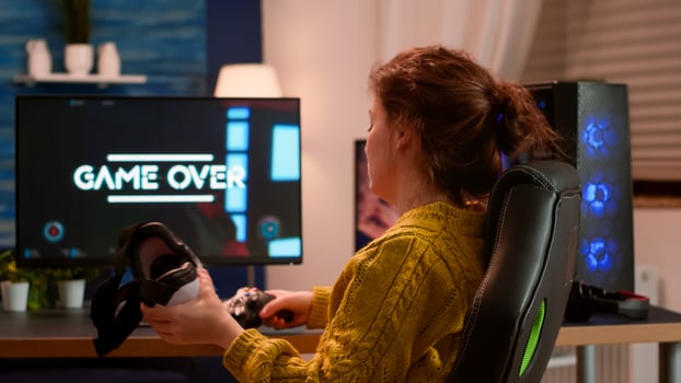 Experienced gamer wearing VR playing at home game using wireless controller, relaxing at night. Online streaming cyber performing on powerful personal computer during gaming tournament photo
