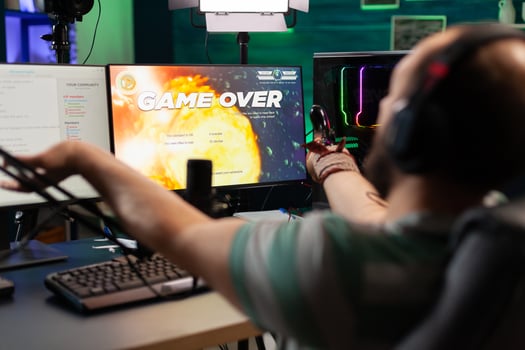 Game over for man streamer playing online space shooter game using modern headseat and joystick. Cyber performing on powerful pc talking with players on chat open during professional competition photo