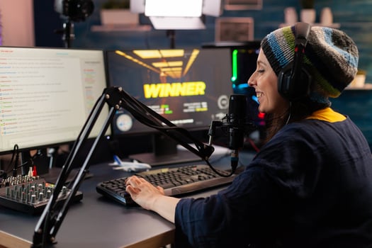 Game over for man streamer playing online shooter game using modern headseat and joystick. Cyber performing on powerful pc talking with players on chat open during professional competition photo