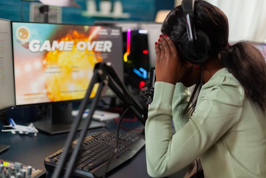Disappointed african online game streamer losing championship, internet multiplayers. Professional gamer streaming online games with new graphics on powerful computer. photo