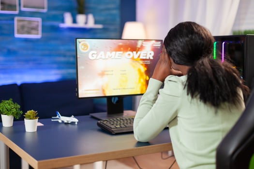 Disappointed sad african woman after losing online game competition Angry professional gamer gaming over during an space shooter online game. photo