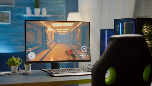 Empty cyberspace with RGB powerful personal computer with first-person shooter game on screen in gaming studio with no people at desk prepared for online esports tournament. Room with no people photo