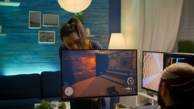 Girlfriend shuts down pro gamer computer during first person tournament in gaming home studio. Cyber player streaming online games using powerful RGB system desktop in room with neon light photo
