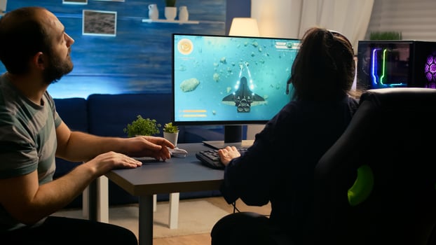 Pro gamer couple playing space shooter games sitting on gaming chiar wearing headphones. Professional digital player streaming game with modern graphics for online game championship photo