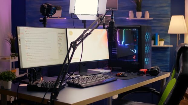 Empty streaming home studio equipped with professional streaming equipment. Pro streamer losing space shooter game during online tournament late at night in gaming studio photo