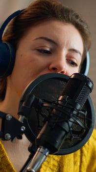 Woman checking sound before recording live podcast in home studio. Lady presenter making on-air online production internet broadcast show host with streaming station, media equipment and laptop, photo
