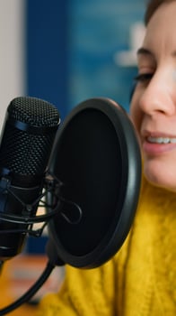 Creative influencer with headphones speaking during livestreaming, blogger discussing in podcast on social media. On-air online production internet broadcast show host streaming live content photo