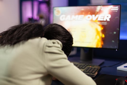 Sad loser gamer person playing space shooter games losing online championship. Nervous african american player using RGB computer equipment sitting in gaming home studio. Esports tournament photo