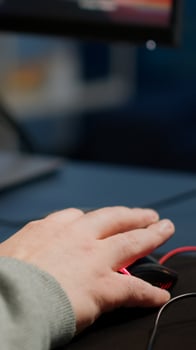 Close-up of man hands gamer playing game using RGB keyboard during virtual championship in cyberspace. Online streaming cyber performing on powerful personal computer during gaming tournament photo