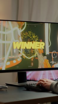 Exciting professional esport gamer celebrates championship victory raising hands wearing professional headset. Pro cyber man winning FPS videogame during online gaming tournament, live streaming event photo