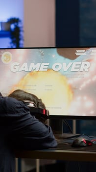 Angry pro woman gamer losing space shooter game during online championship. Cyber player testing virtual games using powerful personal computer in gaming room during esports tournament photo