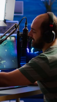 Man streamer cyber checking sound at mixer performing space shooter game on RGB powerful computer talking with players on stream chat and microphone in gaming competition. Player man streaming photo