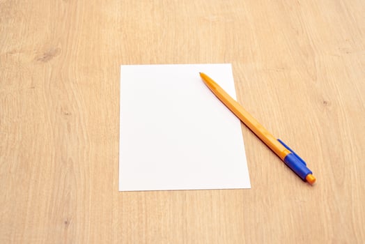 blank a 4 paper and a pen on a table photo