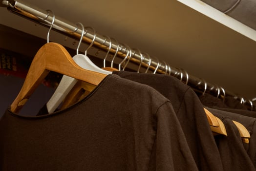 black t-shirts on wooden hangers photo