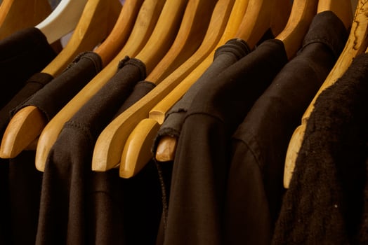 black t-shirts on wooden hangers photo