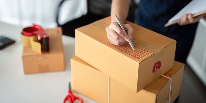 Online Ecommerce Business Preparing Parcel Boxes for Product Delivery and Shipping photo