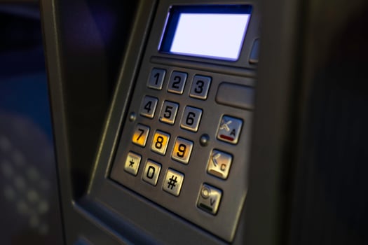 Close-up view of an ATM keypad with illuminated buttons in a low-light setting photo
