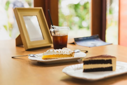 Fresh lemon meringue pie on wooden table in cafe. photo