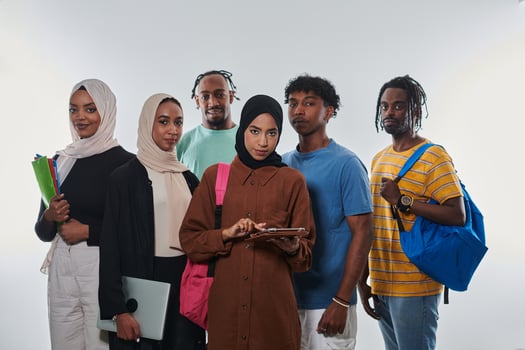 Group of diverse students engages in modern educational practices, utilizing a variety of technological tools such as laptops, tablets, and smartphones against a clean white background, exemplifying photo