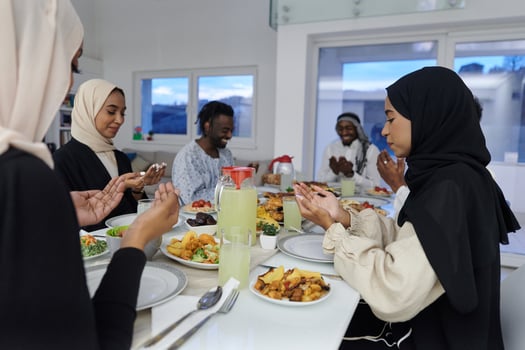 In the sacred month of Ramadan, a diverse Muslim family comes together in spiritual unity, fervently praying to God before breaking their fast, capturing a moment of collective devotion, cultural photo