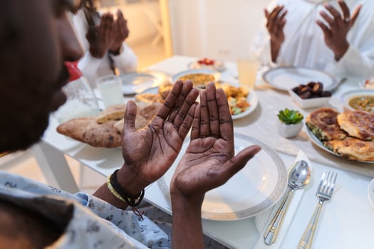 In the sacred month of Ramadan, a diverse Muslim family comes together in spiritual unity, fervently praying to God before breaking their fast, capturing a moment of collective devotion, cultural photo