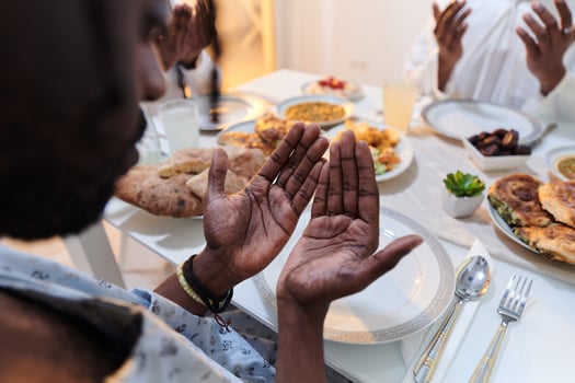 In the sacred month of Ramadan, a diverse Muslim family comes together in spiritual unity, fervently praying to God before breaking their fast, capturing a moment of collective devotion, cultural photo