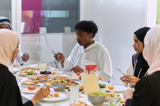 A traditional and diverse Muslim family comes together to share a delicious iftar meal during the sacred month of Ramadan, embodying the essence of familial joy, cultural richness, and spiritual unity photo