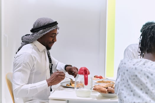 A traditional and diverse Muslim family comes together to share a delicious iftar meal during the sacred month of Ramadan, embodying the essence of familial joy, cultural richness, and spiritual unity photo