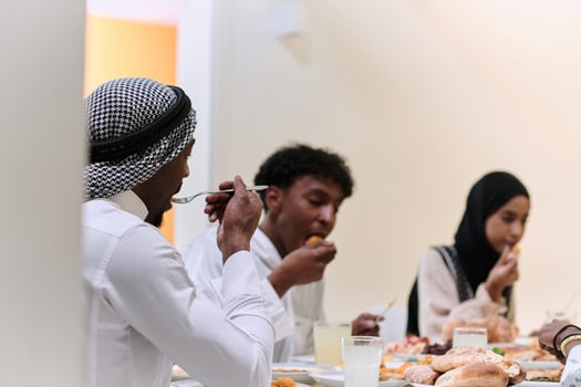 A traditional and diverse Muslim family comes together to share a delicious iftar meal during the sacred month of Ramadan, embodying the essence of familial joy, cultural richness, and spiritual unity photo