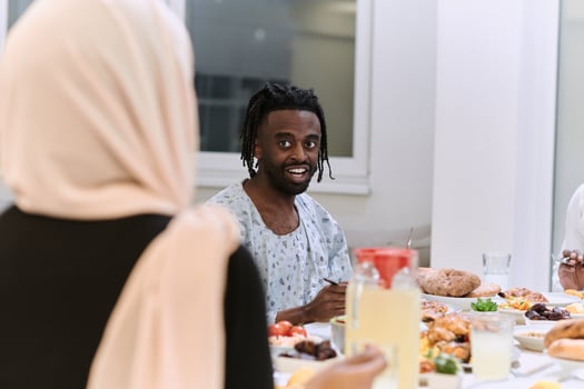 A traditional and diverse Muslim family comes together to share a delicious iftar meal during the sacred month of Ramadan, embodying the essence of familial joy, cultural richness, and spiritual unity photo