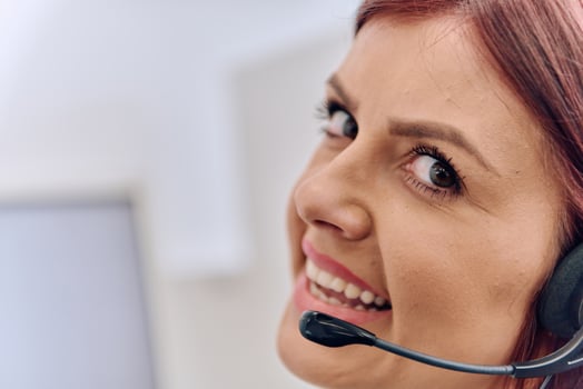 Friendly Call Center Agent Answering Incoming Calls with Headset Providing Remote Customer Service. photo
