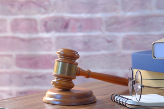 Close up of gavel, book and handcuff on table photo