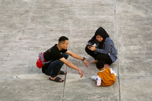 Jakarta, Indonesia, 2024 - Family Quality Time, Bonding Moment Outdoors with Mother Father and Child photo