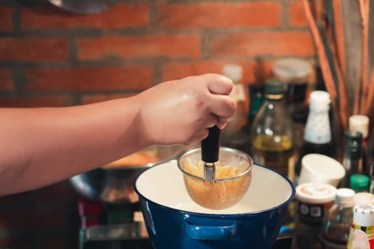 Process of cooked homemade tomato sauce for pasta or spaghetti in a pan with a wooden spoon. Closeup photo