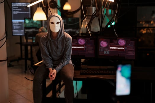 Anonymous hacker recording ransomware , hacking computer system and breaking into online server. attacking database. Woman thief stealing information, planting virus on software. photo