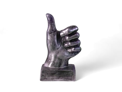 silver hand decoration with a thumbs up on a white background photo