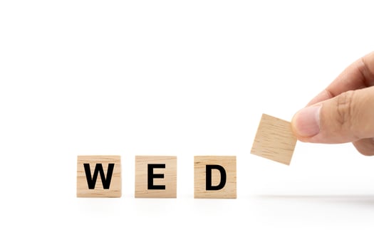 Hand place wooden blocks with WED text isolated on white background. Wednesday and Calendar concept. Copy space. photo