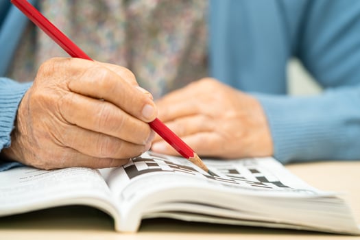 Alzheimer disease AD, Asian elderly woman playing sudoku puzzle game to practice for dementia prevention. photo