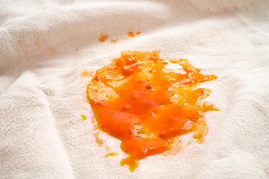 Dirty tomato sauce stain or ketchup on cloth to wash with washing powder, cleaning housework concept. photo