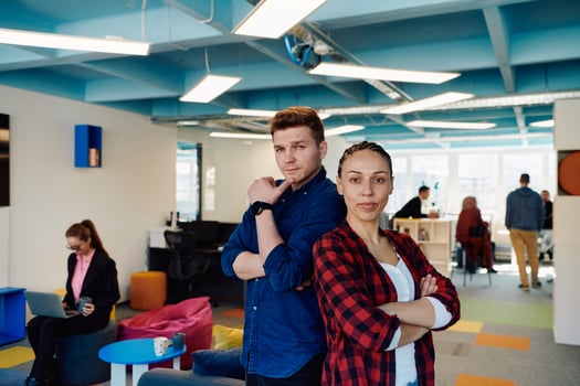 Portrait of a successful creative businessman and businesswoman looking at camera and smiling. Diverse business people standing together at startup. photo