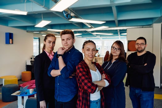 Portrait of a successful creative businessman and businesswoman looking at camera and smiling. Diverse business people standing together at startup. photo
