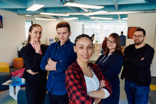 Portrait of a successful creative businessman and businesswoman looking at camera and smiling. Diverse business people standing together at startup. photo