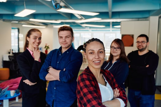 Portrait of a successful creative businessman and businesswoman looking at camera and smiling. Diverse business people standing together at startup. photo