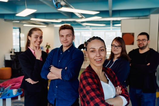 Portrait of a successful creative businessman and businesswoman looking at camera and smiling. Diverse business people standing together at startup. photo