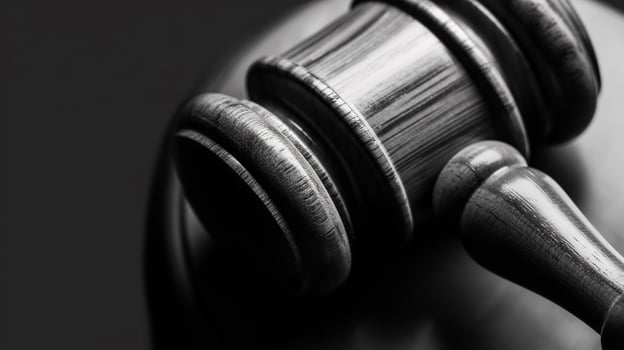 Photo of a judge's gavel to make a fair legislative decision in a criminal case in courtroom close up