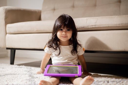 Portrait of a child holding a digital tablet on indoors. photo