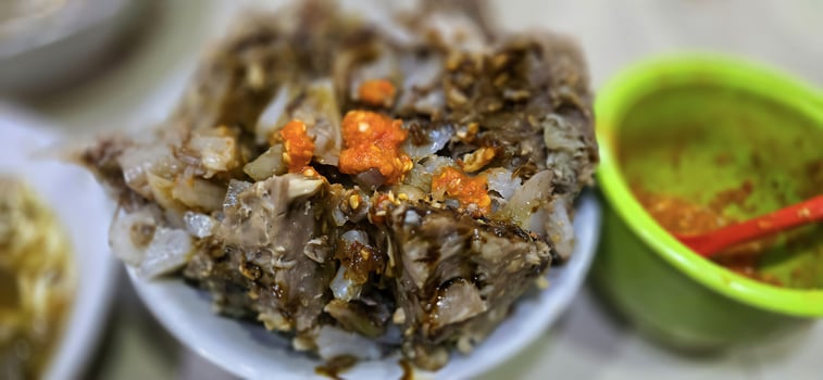 Giant Bakso, or Jumbo meatball is indonesian meatball style served with beef broth soup and noodle springkled with fried onion and spring onion coupled with chili sauce on the top photo