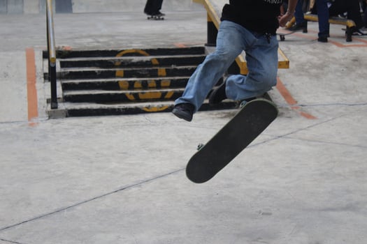 An asian man doing tricks on a skateboard. Indonesia - Medan, 21 June 2024 photo
