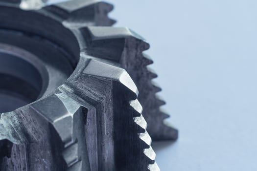 Close up view of a fragment of steel milling cutter on white background with copy space photo