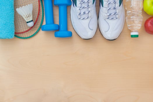 Attributes of a healthy lifestyle food, sports or athlete's equipment on wooden surface photo